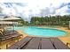 Resort-style pool with tanning ledges, lounge chairs, splash pad, and lush landscaping at 313 Squire Pope Rd, Summerville, SC 29486