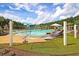 Community pool area with splash pad, hammocks and umbrellas on a sunny day at 313 Squire Pope Rd, Summerville, SC 29486