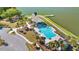 Aerial view of the community pool and lake with a dock area and lounge chairs at 3431 Great Egret Dr, Johns Island, SC 29455