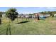 View of backyard with a playset and fenced in yard in a well manicured community at 3431 Great Egret Dr, Johns Island, SC 29455