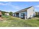 View of backyard with a playset, solar panels on the home, and plenty of yard space at 3431 Great Egret Dr, Johns Island, SC 29455