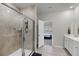 A bright bathroom featuring a glass enclosed shower and stylish vanity with an adjoining bedroom view at 3431 Great Egret Dr, Johns Island, SC 29455