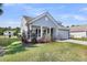 Home features a cozy front porch and attached garage, all set on a well-maintained lawn at 3431 Great Egret Dr, Johns Island, SC 29455