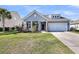 Charming home with a covered porch, well-manicured lawn, and an attached two-car garage at 3431 Great Egret Dr, Johns Island, SC 29455