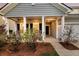 Charming front porch with rocking chairs and landscaping at 3431 Great Egret Dr, Johns Island, SC 29455
