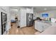 Modern kitchen with stainless steel refrigerator, white cabinets and granite countertops at 3431 Great Egret Dr, Johns Island, SC 29455