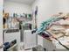A functional laundry room with shelving, washer, dryer, and ample space for sorting and storing clothes at 3431 Great Egret Dr, Johns Island, SC 29455