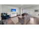 Open living area featuring hardwood floors, large windows, neutral paint, and modern furnishings at 3431 Great Egret Dr, Johns Island, SC 29455