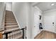 Carpeted stairs with railing and view into entryway of home at 3431 Great Egret Dr, Johns Island, SC 29455