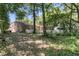 View of the backyard, with a brick house, white fence, swing set, and trees at 356 Hobcaw Dr, Mount Pleasant, SC 29464