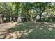 Expansive backyard with lush lawn, swing set, mature trees providing shade, and a privacy fence at 356 Hobcaw Dr, Mount Pleasant, SC 29464