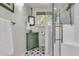 Charming bathroom featuring a stylish vanity with green cabinet and glass enclosed shower with eye-catching tile floors at 356 Hobcaw Dr, Mount Pleasant, SC 29464