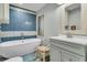 Beautiful bathroom with a modern soaking tub, stylish vanity, and blue tiled accent wall at 356 Hobcaw Dr, Mount Pleasant, SC 29464