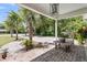 Charming front porch with brick flooring, palm trees, and ample space for outdoor seating, perfect for enjoying the outdoors at 356 Hobcaw Dr, Mount Pleasant, SC 29464