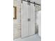 Unique sliding barn doors with black hardware against a painted brick wall at 356 Hobcaw Dr, Mount Pleasant, SC 29464