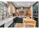 Well-equipped kitchen features brick accents, modern appliances, and ample counter space, perfect for cooking and entertaining guests at 356 Hobcaw Dr, Mount Pleasant, SC 29464