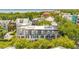 Stunning aerial view of multi-story houses with dormer windows, surrounded by lush greenery and a glimpse of the ocean at 39 N Adgers Wharf, Charleston, SC 29401