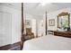 Bedroom showcasing dark wood floors, four-poster bed and antique accent chair at 39 N Adgers Wharf, Charleston, SC 29401