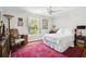 Well-lit bedroom with window shutters, ceiling fan, and antique side tables at 39 N Adgers Wharf, Charleston, SC 29401