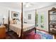 Bedroom featuring a four-poster bed, French doors, and an oriental rug at 39 N Adgers Wharf, Charleston, SC 29401
