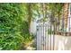 Enchanting brick courtyard featuring wrought iron gate surrounded by lush greenery at 39 N Adgers Wharf, Charleston, SC 29401