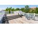 Expansive wooden deck features a dining set and white railing with steps leading down at 39 N Adgers Wharf, Charleston, SC 29401