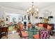 Open dining area with a chandelier, glass table, and access to the living room at 39 N Adgers Wharf, Charleston, SC 29401