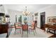 Bright dining room with a chandelier, glass table, and elegant furnishings at 39 N Adgers Wharf, Charleston, SC 29401
