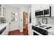 Bright kitchen with white cabinets, updated appliances, and a view to the home's entry at 39 N Adgers Wharf, Charleston, SC 29401