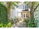 Charming brick patio with spiral staircase and seating area surrounded by lush greenery at 39 N Adgers Wharf, Charleston, SC 29401
