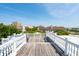 A spacious rooftop deck with white railings showcases a stunning city skyline beyond at 39 N Adgers Wharf, Charleston, SC 29401