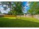 Beautiful backyard featuring a well-maintained lawn, a wooden fence, and a convenient clothesline at 411 Black Horse Rd, Moncks Corner, SC 29461