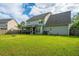 Expansive backyard featuring lush green lawn, a privacy fence, and a screened porch, creating a tranquil retreat at 411 Black Horse Rd, Moncks Corner, SC 29461