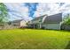 Expansive backyard with lush green lawn and a screened porch at 411 Black Horse Rd, Moncks Corner, SC 29461