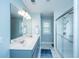 Bright bathroom featuring double sinks with a large mirror, and a glass-enclosed shower at 411 Black Horse Rd, Moncks Corner, SC 29461