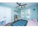 Bright bedroom with a blue rug, ceiling fan, and two large windows at 411 Black Horse Rd, Moncks Corner, SC 29461