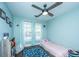 Bright bedroom with a blue rug, ceiling fan, and two large windows at 411 Black Horse Rd, Moncks Corner, SC 29461