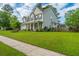 Charming two-story home with a well-manicured lawn and inviting front porch at 411 Black Horse Rd, Moncks Corner, SC 29461