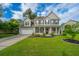 Charming two-story home with a well-manicured lawn and inviting front porch at 411 Black Horse Rd, Moncks Corner, SC 29461