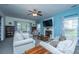 Comfortable living room with fireplace, neutral tones and large windows at 411 Black Horse Rd, Moncks Corner, SC 29461