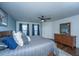 Comfortable main bedroom with a ceiling fan, hardwood floors, and two large windows at 411 Black Horse Rd, Moncks Corner, SC 29461