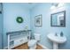 Charming powder room with blue walls, pedestal sink, and modern decor at 411 Black Horse Rd, Moncks Corner, SC 29461