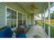 Covered screened porch with wicker furniture and ceiling fan, ideal for outdoor relaxation and enjoyment at 411 Black Horse Rd, Moncks Corner, SC 29461
