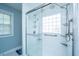 Detail of the modern shower with a glass door, grab bars, and a tiled surround at 411 Black Horse Rd, Moncks Corner, SC 29461
