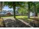 Large backyard with mature trees, storage shed, and wooden deck at 414 Courtland Dr, Summerville, SC 29486