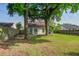 View of the backyard with mature trees and a small deck at 414 Courtland Dr, Summerville, SC 29486