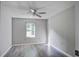 Bedroom featuring a ceiling fan, gray walls, new wood-look flooring, and a window view of the yard at 414 Courtland Dr, Summerville, SC 29486