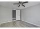 Bedroom featuring a ceiling fan, gray walls, updated wood-look flooring, and access to an ensuite at 414 Courtland Dr, Summerville, SC 29486