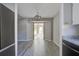 Dining room featuring a modern light fixture, gray walls, updated gray flooring, and sunroom access at 414 Courtland Dr, Summerville, SC 29486