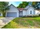 Charming single-story home featuring a gray garage door and tidy front lawn at 414 Courtland Dr, Summerville, SC 29486